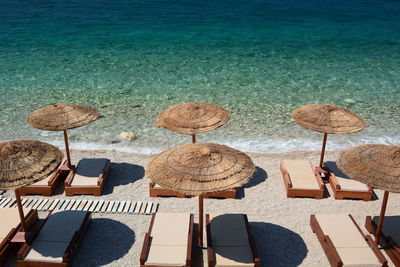 High angle view of parasols on table by sea