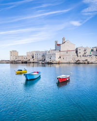 Boats in sea against sky