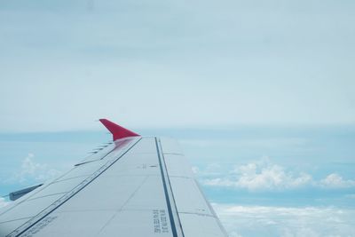 Airplane flying over sea against sky