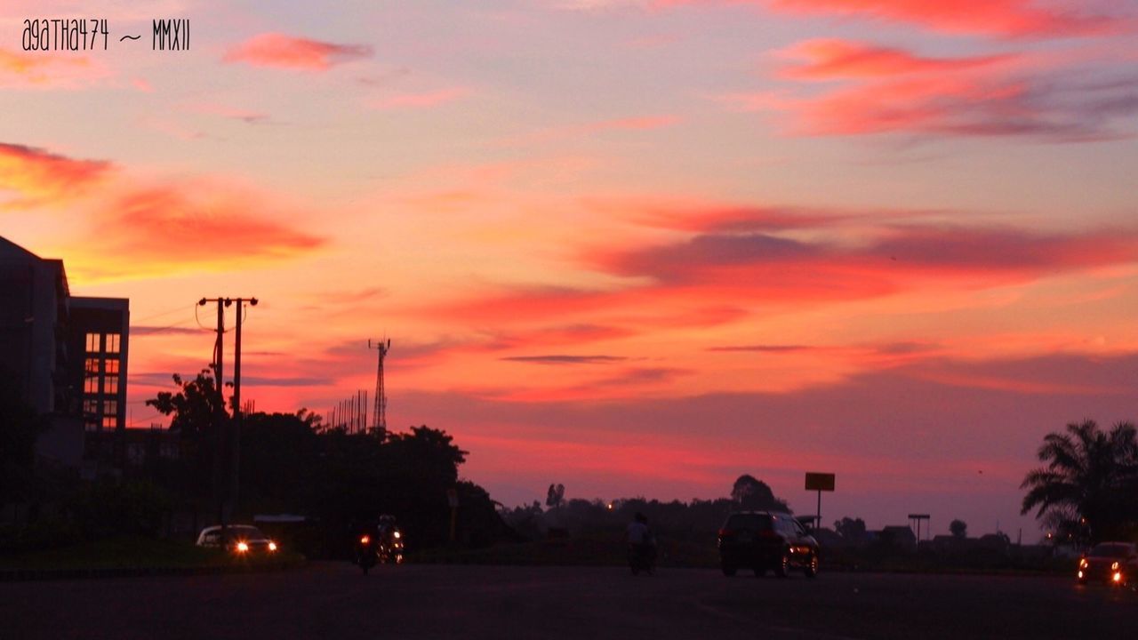 sunset, sky, silhouette, orange color, cloud - sky, tree, street light, illuminated, transportation, car, building exterior, dramatic sky, street, dusk, road, land vehicle, built structure, beauty in nature, cloud, nature