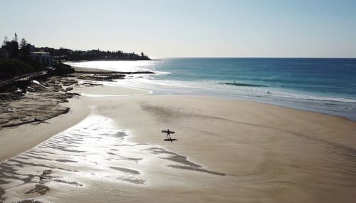 Scenic view of beach against clear sky