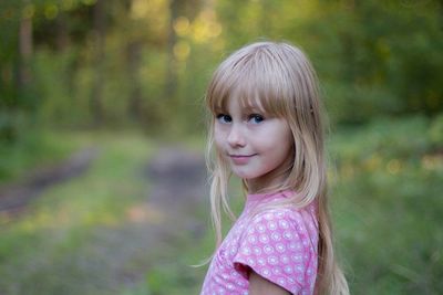 Portrait of girl standing on field