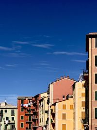 Low angle view of buildings against blue sky