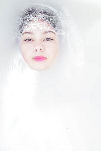 Portrait of a beautiful young woman over white background