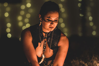 Young woman looking away at night