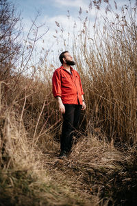 Full length of young man standing on field