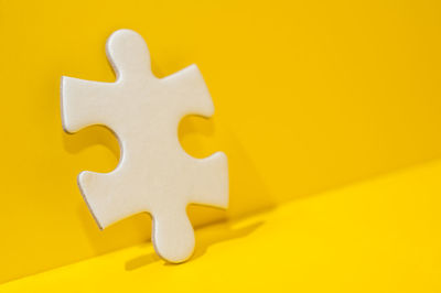 High angle view of arrow symbol on yellow background