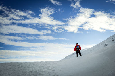 Man climbing on mountain road against sky