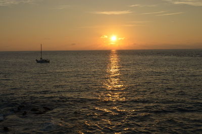 Scenic view of calm sea at sunset