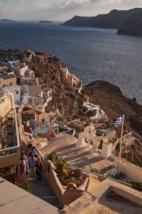 High angle view of townscape by sea against sky