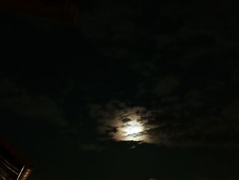Low angle view of silhouette moon in sky at night