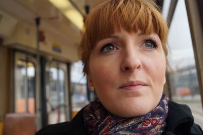 Close-up of thoughtful woman looking away in tram