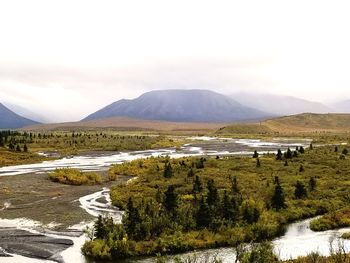 Scenic view of lake and mountains against sky