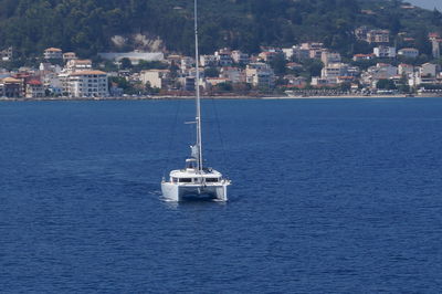 Ship in sea against mountain