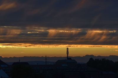 Silhouette buildings against sky during sunset