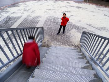 High angle view of woman standing on snow