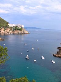 High angle view of boats sailing in sea against sky