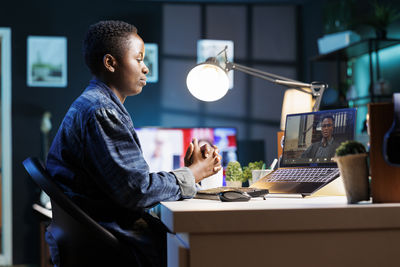 Side view of man working at office