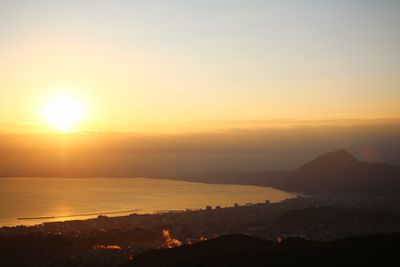 Scenic view of silhouette mountains against sky during sunset