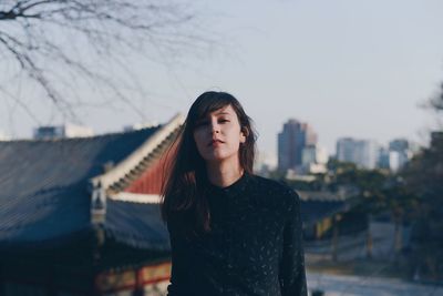 Portrait of beautiful woman against sky