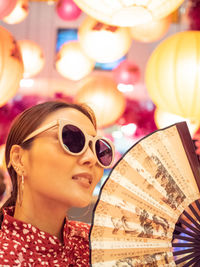 Close-up portrait of woman wearing sunglasses