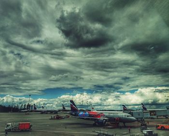 Airplane on runway against sky