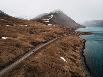 Scenic view of land and mountains against sky