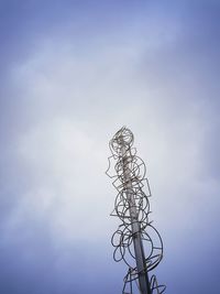 Low angle view of telephone pole against sky