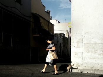 People walking on horse against sky