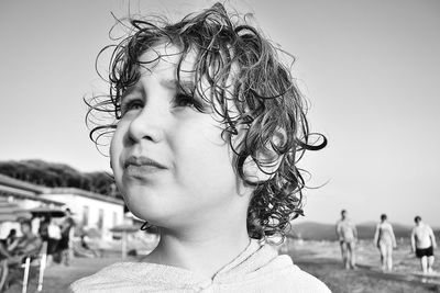 Close-up portrait of girl against sky