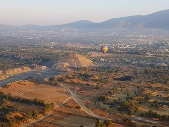 High angle view of hot air balloon over ancient pyramid