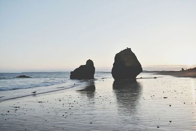 Scenic view of sea against clear sky during sunset