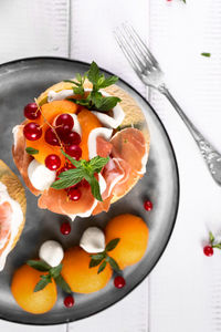 High angle view of fruits in plate on table