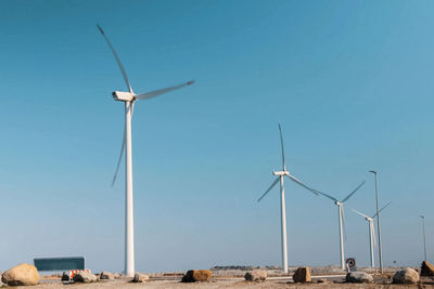 Low angle view of windmill on land against clear sky