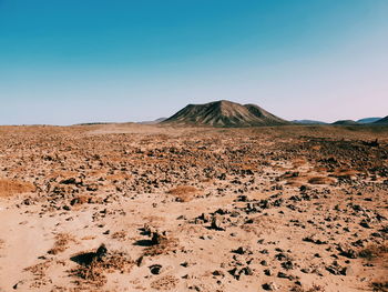 Scenic view of desert against clear sky