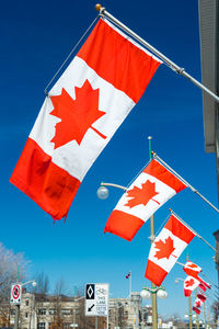 Low angle view of flag against blue sky