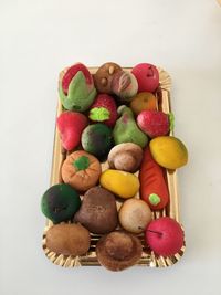 High angle view of multi colored candies against white background