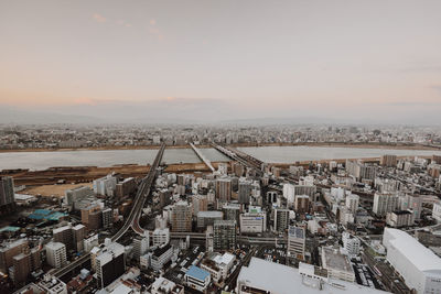 High angle view of city buildings against sky during sunset