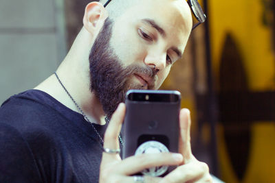 Portrait of young man using mobile phone