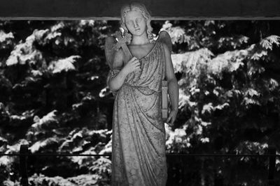 Marble funerary statue in a small mountain cemetery