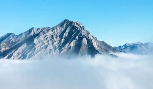 Scenic view of snowcapped mountains against clear blue sky