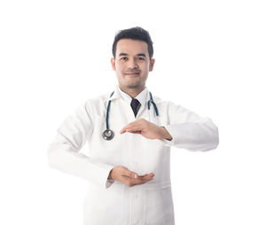 Midsection of doctor showing protection gesture over white background