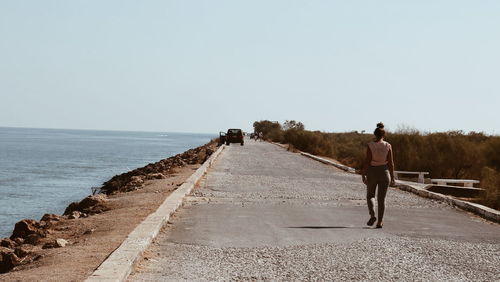 Rear view of woman walking on street