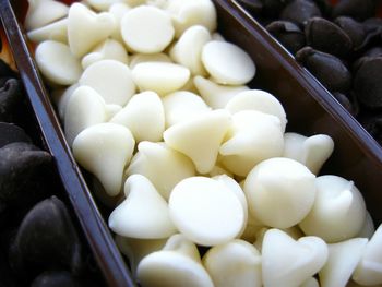 Close-up of white chocolate chips in container