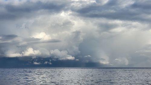 Scenic view of sea against storm clouds