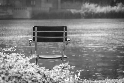 Empty chair against lake