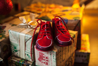 Close-up of red shoes on christmas presents at home