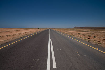 Empty road against clear sky