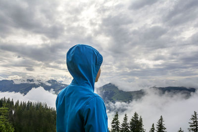 Rear view of person standing in mountains