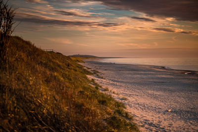 Scenic view of beach against sky during sunset